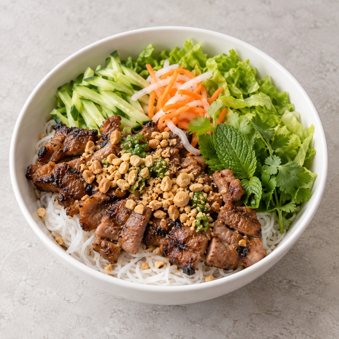 Grilled pork over rice vermicelli with fresh lettuce